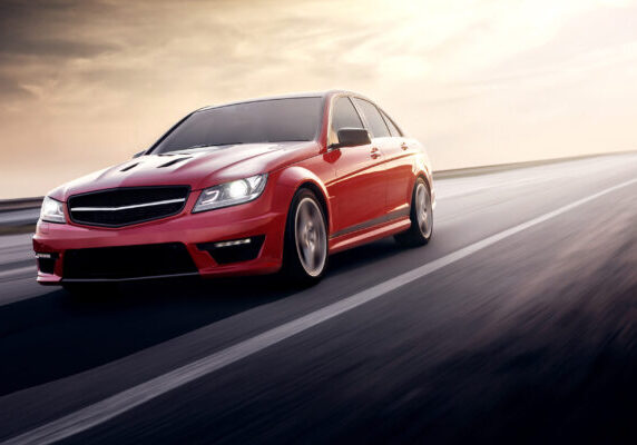 Fast drive red sport car speed on the road