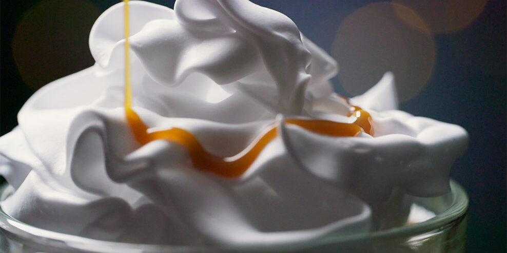 Closeup of the cream of a milkshake.